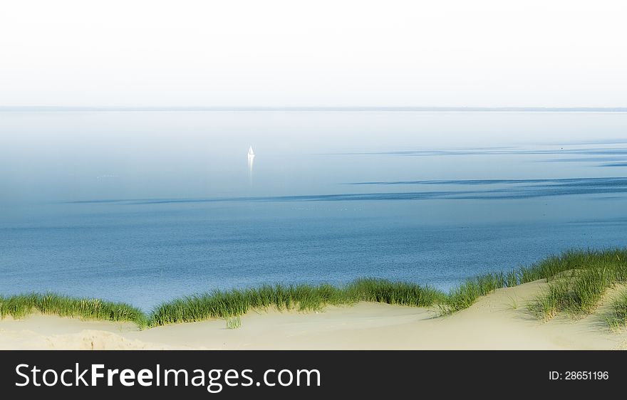 Lonely Yacht or Boat is Visible Far from the shores in a Dreamy Calm Water. Lonely Yacht or Boat is Visible Far from the shores in a Dreamy Calm Water