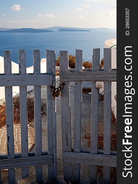 Wooden gates close access to the sea. Greece, Santorini island. Wooden gates close access to the sea. Greece, Santorini island