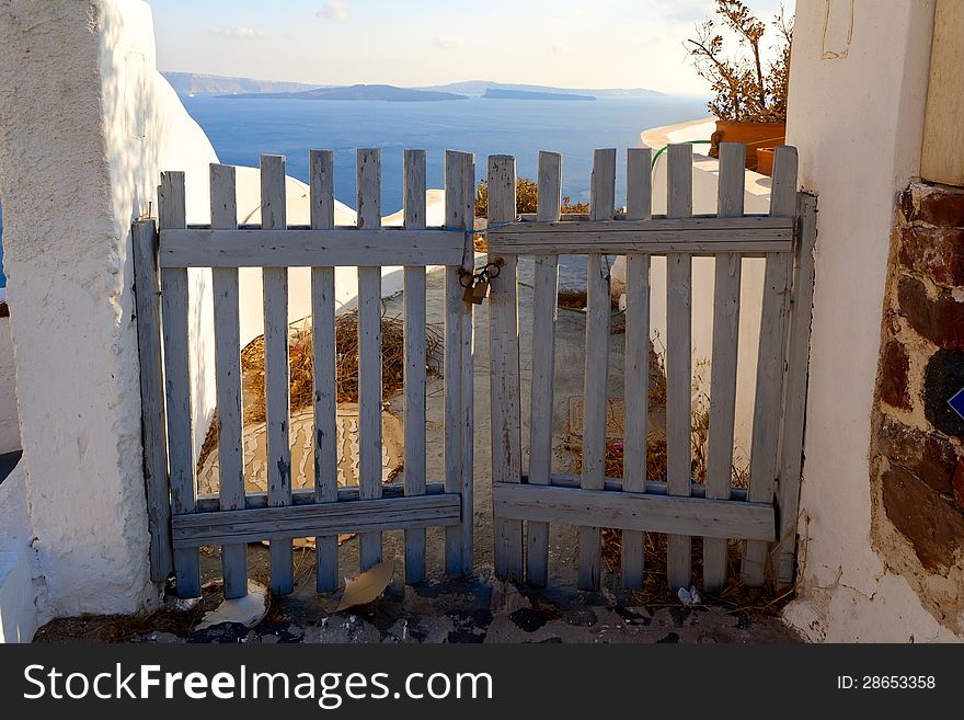 Wooden gates close access to the sea. Greece, Santorini island. Wooden gates close access to the sea. Greece, Santorini island