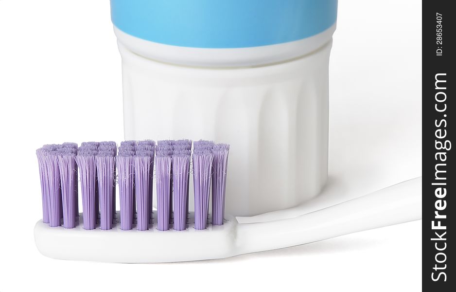 Toothbrush and toothpaste on a white background