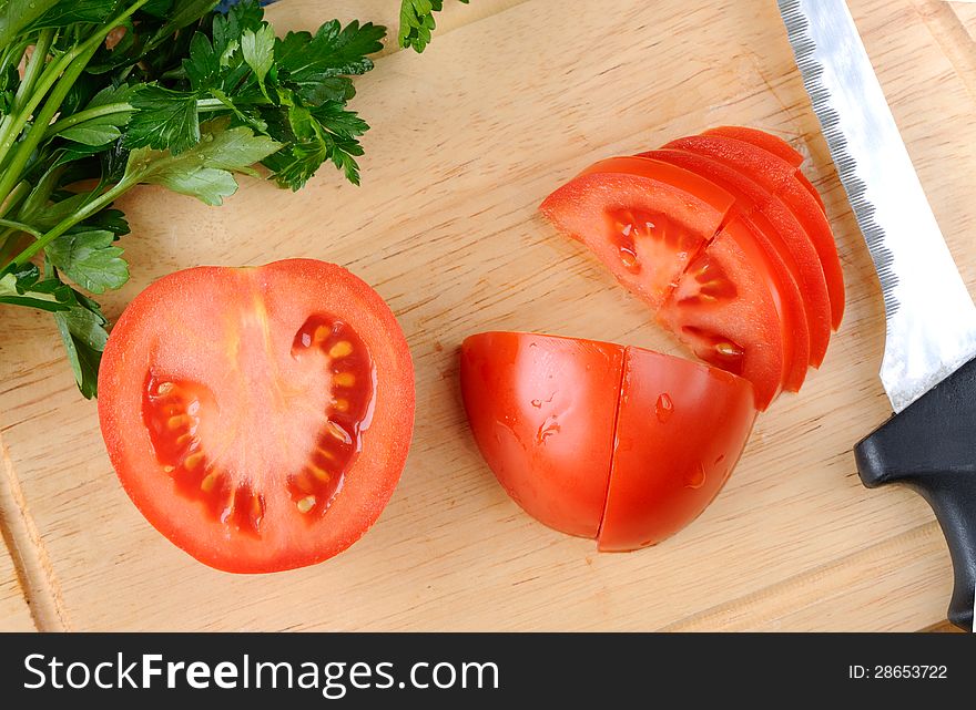 Cutting board with knife and tomatoes