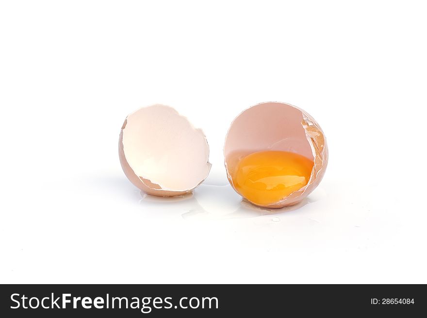 Broken brown egg on white background. Broken brown egg on white background