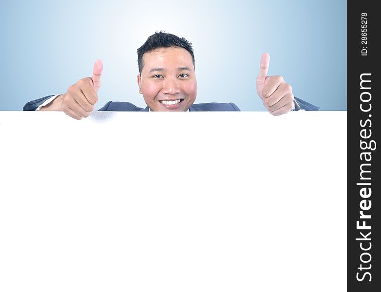 Business man holding white board with thumb up