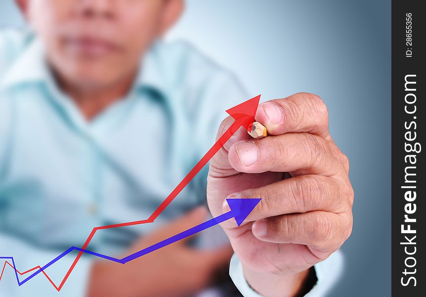 Business man drawing growth graph of success with red color and blue color