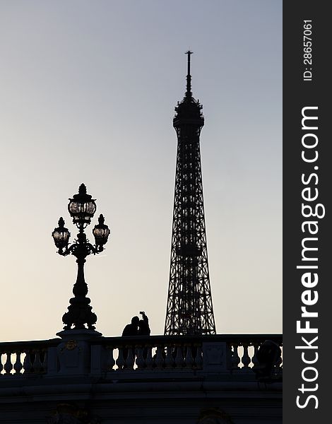 Silhouette Eiffel Tower with lamp, lovers on the bridge, Paris, France