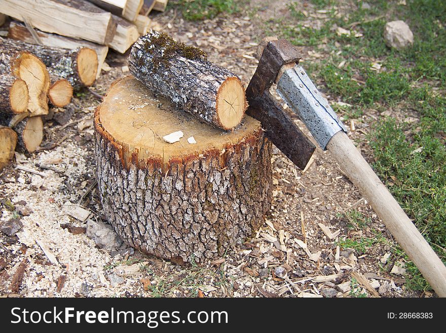 Stack of fresh firewood prepare to split with axe