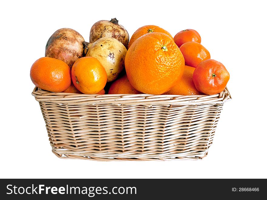 Fresh mandarins,oranges and pomegranates in wicker basket over white background. Fresh mandarins,oranges and pomegranates in wicker basket over white background