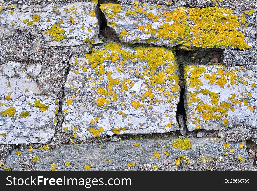 Rocks and lichen. Brick masonry of the old barn.