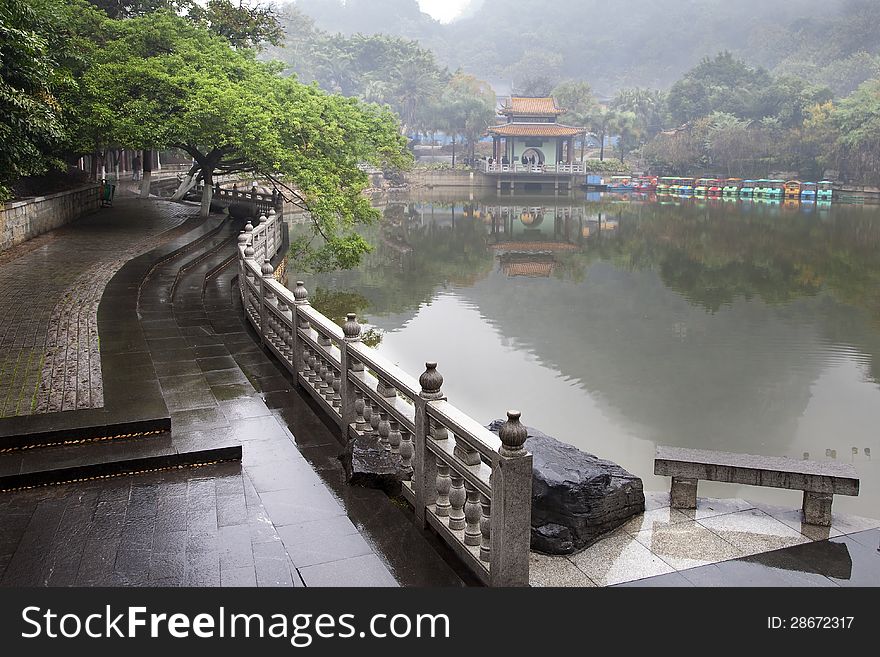 Rainy park in misty day