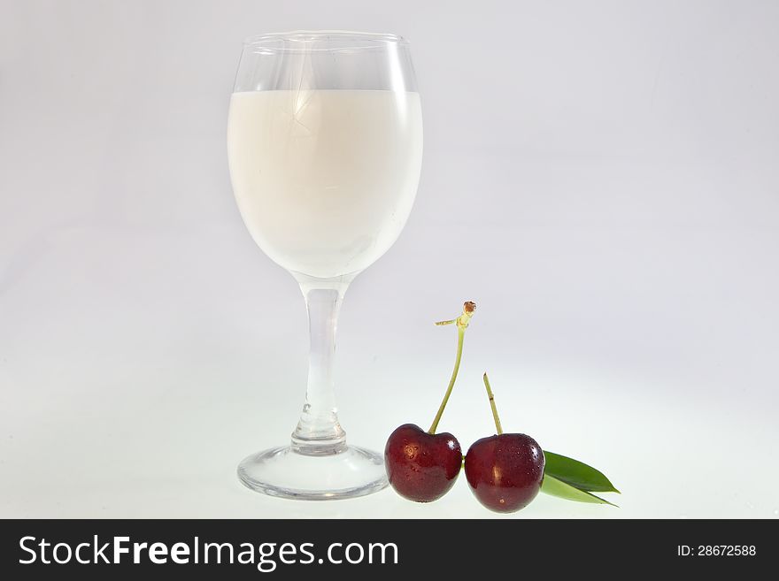 A cup of drink and cherry