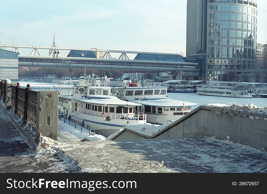 Boats  iced on the river urban landscape. Boats  iced on the river urban landscape