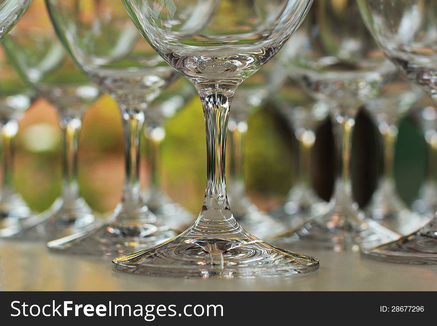 Crystal clear wine glasses standing in a neat row on a table