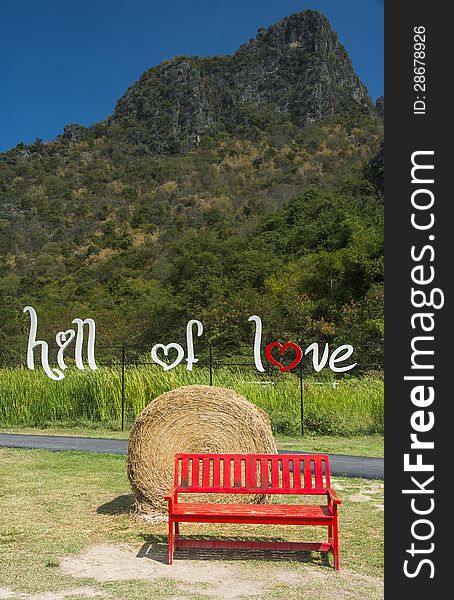 Long red bench in the farm of the hill of love. Long red bench in the farm of the hill of love