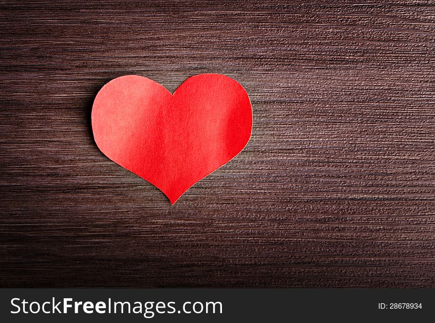 Valentine s Day background. red heart on a wooden background