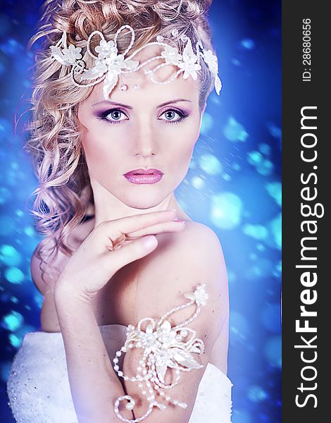 Portrait of a beautiful young bride in a white dress