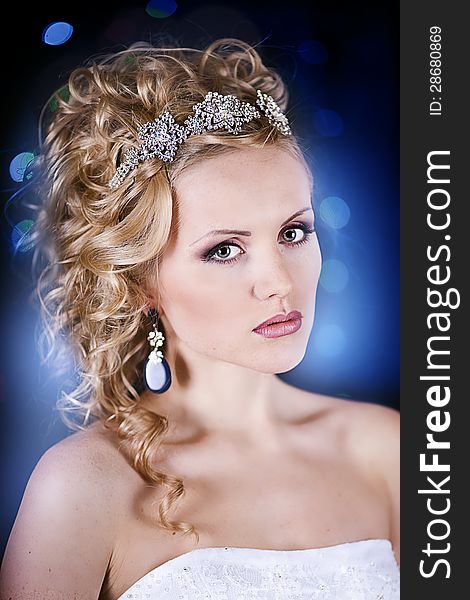 Portrait of a beautiful young bride in a white dress