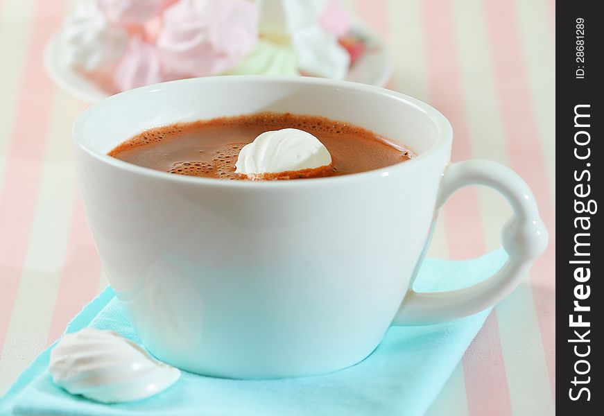 Hot chocolate and meringue cookies on pastel color background