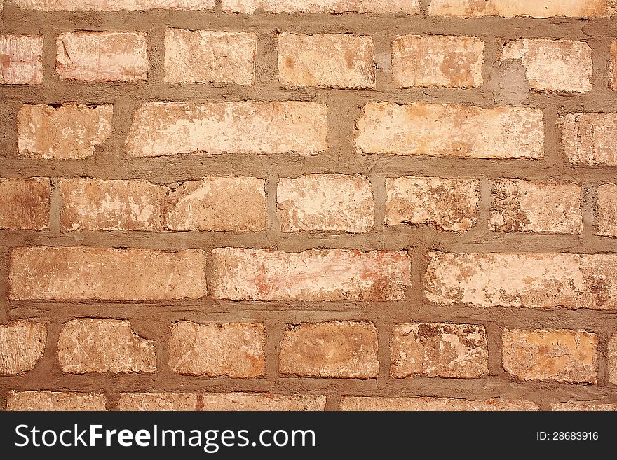 Old gray brick wall as background closeup