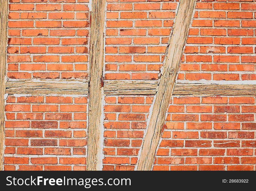 Old red brick wall with wooden beams as background