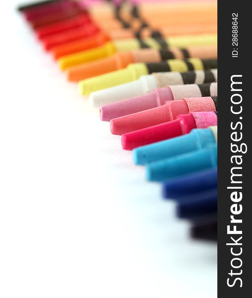 Beautiful colorful pastel(crayon) pencils in a row(line) on white background with copy space for text. Beautiful colorful pastel(crayon) pencils in a row(line) on white background with copy space for text