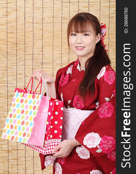 Young asian woman in traditional clothes of kimono with shopping bags. Young asian woman in traditional clothes of kimono with shopping bags