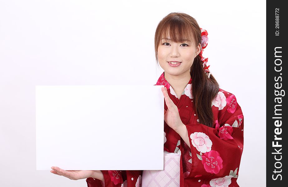 Young asian woman in traditional clothes of kimono holding a blank board. Young asian woman in traditional clothes of kimono holding a blank board