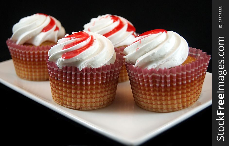 Homemade cupcakes with cream and strawberry jam