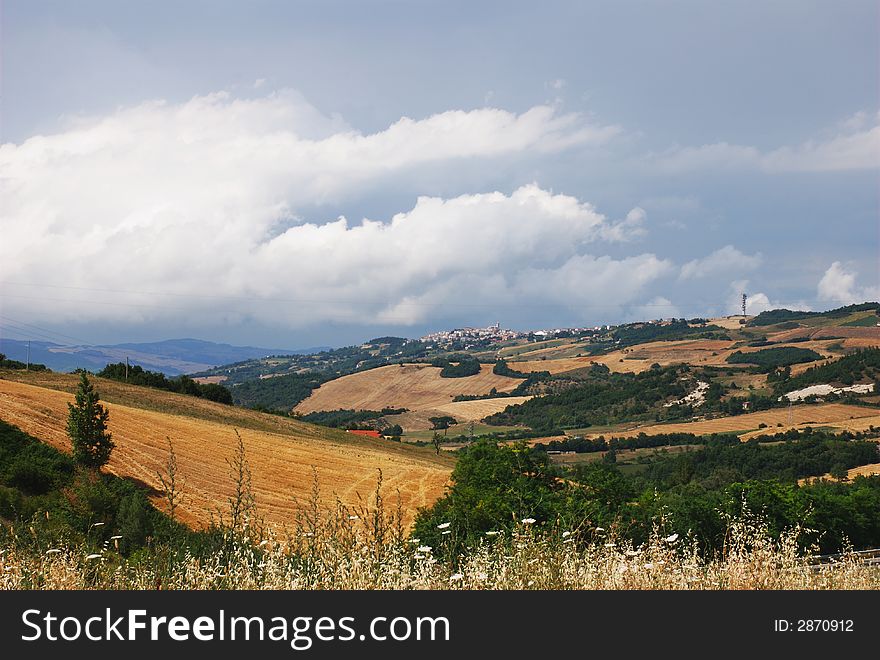 Summertime stormy clouds threatening a little italian village