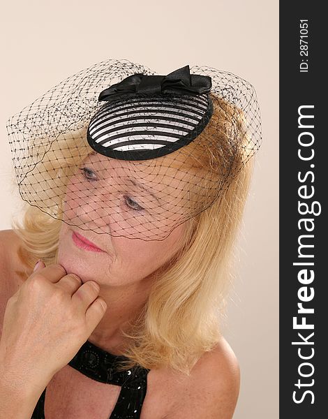 Elegant mature blond lady with small hat. Elegant mature blond lady with small hat