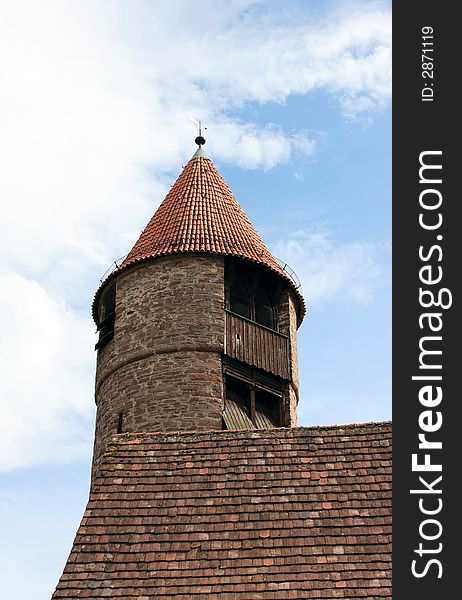 This image shows a medieval watchtower with clouds. This image shows a medieval watchtower with clouds