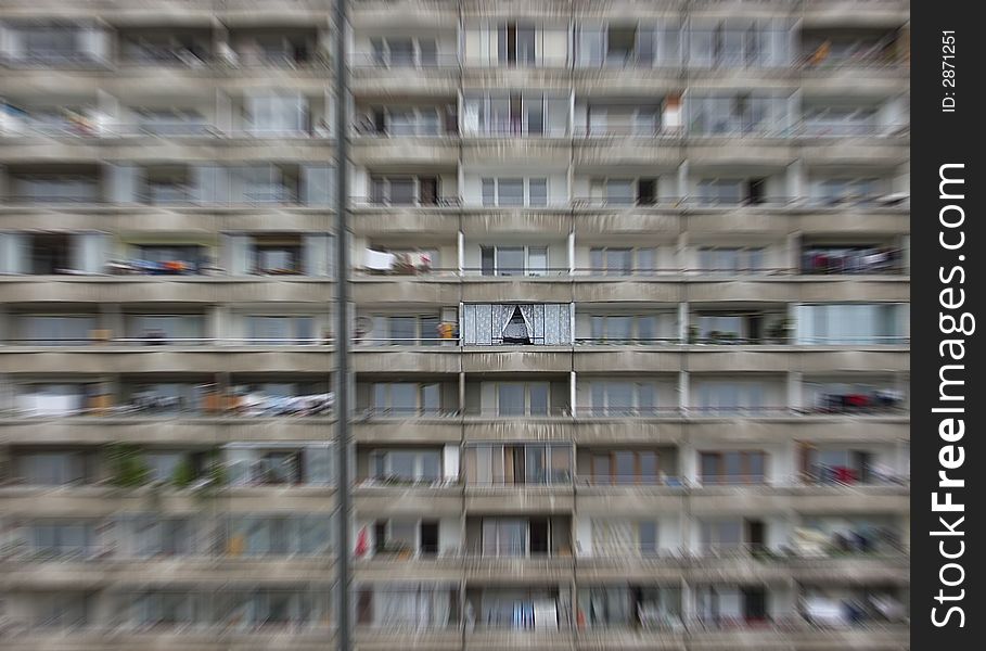 Depressive prefab house with cosy balcony highlighted by radial blur (zoom) effect. Socialist architecture, Petrzalka, Bratislava, Slovakia.