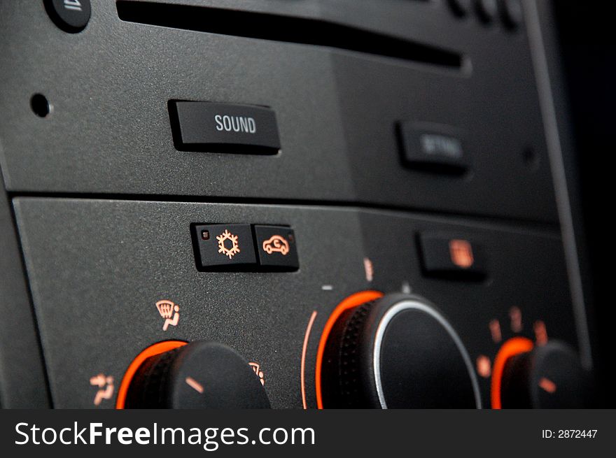 A car radio with light orange buttons