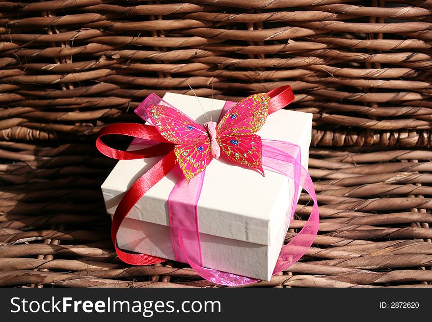 Gift box with a butterfly and ribbon used as decorations