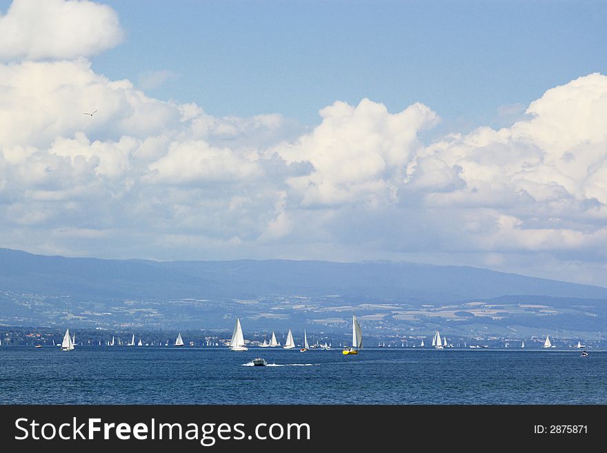 Many yachts in Geneva lake under white clouds. Geneva, Switzerland, EU. Many yachts in Geneva lake under white clouds. Geneva, Switzerland, EU