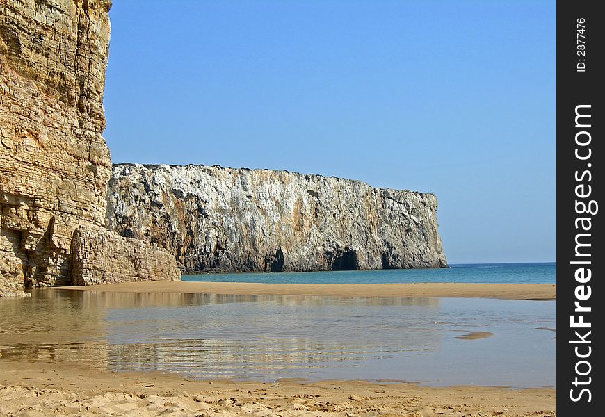 Pool of water reflecting off cliff with clear blue sky. Pool of water reflecting off cliff with clear blue sky