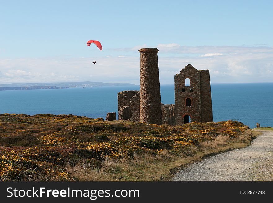 A para glider, gliding past a tin mine on the Cornish coast. A para glider, gliding past a tin mine on the Cornish coast