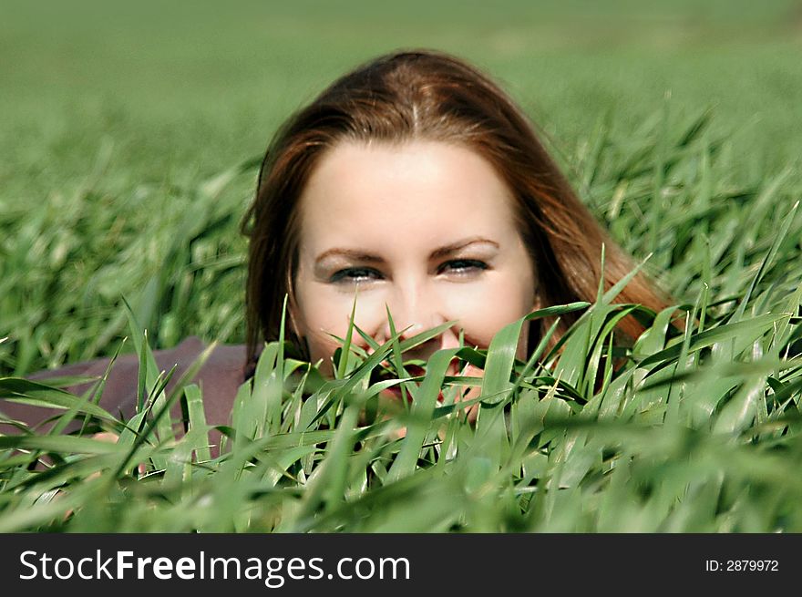 Beautiful and lively girl, in the green grass