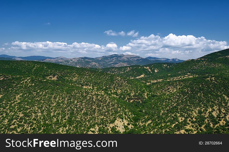 The landscape from the green mountains and blue cloudy sky in Crimea. The landscape from the green mountains and blue cloudy sky in Crimea