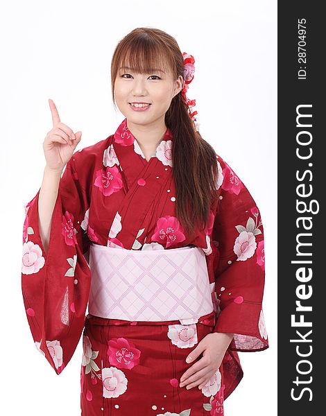 Young asian woman in traditional clothes of kimono, pointing up. Young asian woman in traditional clothes of kimono, pointing up