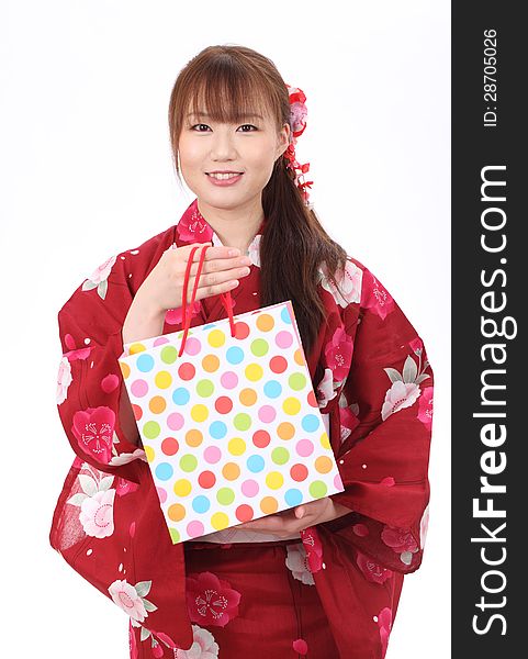 Young asian woman in traditional clothes of kimono with shopping bags. Young asian woman in traditional clothes of kimono with shopping bags
