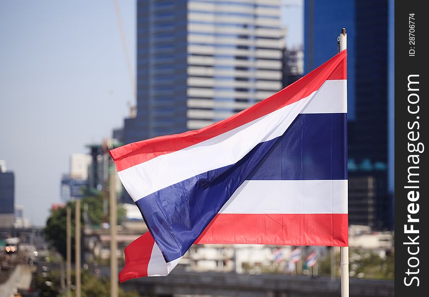 National flag of Thailand with a city background