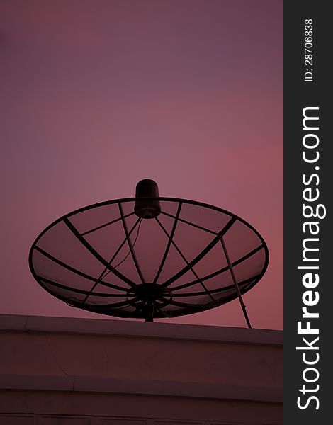 Satellite dish in the city at sunset and colorful sky. Satellite dish in the city at sunset and colorful sky