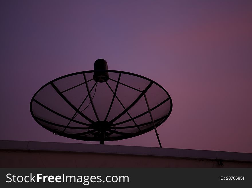 Satellite dish in the city at sunset and colorful sky. Satellite dish in the city at sunset and colorful sky