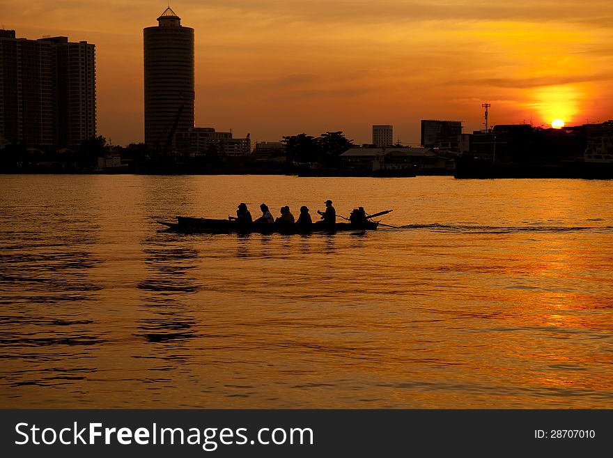 Small ferry boat, Chao Phraya River at sunset, Bangkok, Thailand