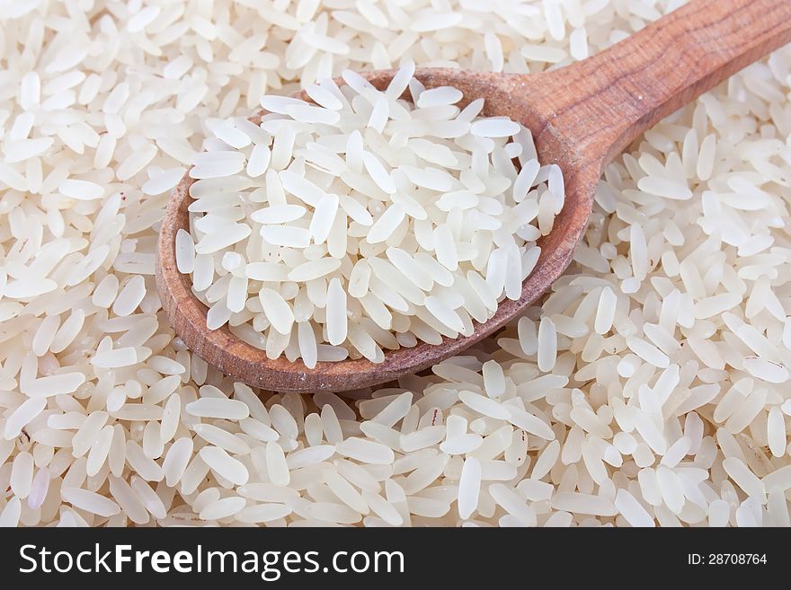 Raw white rice in wooden spoon on burlap, food ingredient photo. Raw white rice in wooden spoon on burlap, food ingredient photo