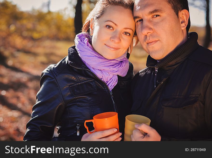 Young Family Drinking Coffee Outdoors