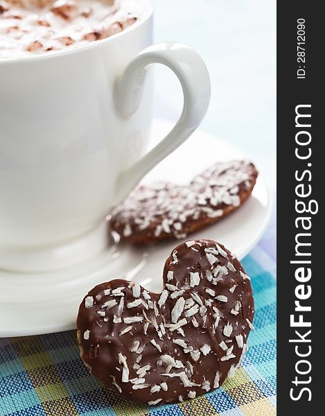 Cup of coffee with heart shaped chocolate cookie. Cup of coffee with heart shaped chocolate cookie