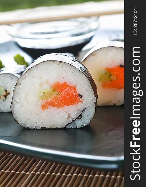 Selection of Japanese sushi arranged on black plate