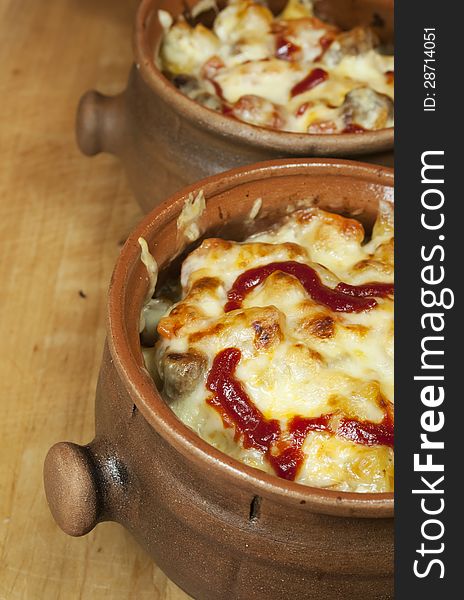 Meat And Vegetables With Cheese And Ketchup  In Pots