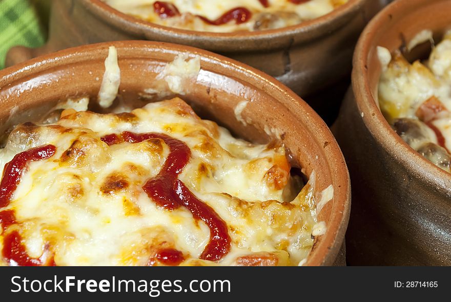 Meat And Vegetables With Cheese And Ketchup  In Pots